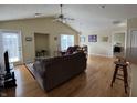 Spacious living room with hardwood floors, vaulted ceilings, and a cozy seating area at 706 Shagbark Ct, Plainfield, IN 46168