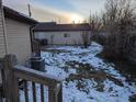 Snow-covered backyard with a detached garage and wooden fence at 710 Indianapolis Ave, Lebanon, IN 46052