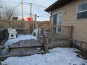 Wooden deck with white benches, partially covered in snow at 710 Indianapolis Ave, Lebanon, IN 46052