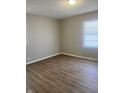 Spacious bedroom with wood-look flooring and neutral walls at 9710 E 38Th St, Indianapolis, IN 46235