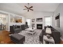 Bright living room features a fireplace, vaulted ceiling, and plush seating, perfect for relaxing or entertaining at 12243 Carriage Stone Dr, Fishers, IN 46037