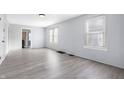 Spacious living room with light gray walls and wood-look flooring at 1629 Sharon Ave, Indianapolis, IN 46222