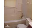 Small bathroom with a bathtub, toilet and single sink at 3726/3722/3716 N Emerson Ave, Indianapolis, IN 46218
