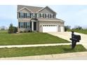 Two-story home with gray brick and siding, green lawn, and mailbox at 373 Brianne Lane at 373 Brianne Ln, Danville, IN 46122