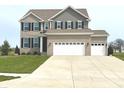 Two-story home with brick and siding, complemented by a well-manicured lawn and a spacious three-car garage at 373 Brianne Ln, Danville, IN 46122