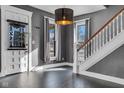 Bright entryway with gray walls, hardwood floors, and staircase at 3816 Rookwood Ave, Indianapolis, IN 46208