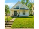 Well-maintained single-story home with a covered porch and a lush green lawn at 3816 Rookwood Ave, Indianapolis, IN 46208