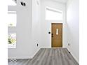 Bright entryway with wood door, gray vinyl flooring, and high ceilings at 459 N Concord St, Indianapolis, IN 46222