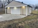 Detached garage with white door and light gray siding at 633 S 17Th St, Elwood, IN 46036