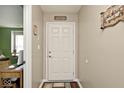 Bright entryway with a six-panel door and wood flooring at 6438 Emerald Springs Dr, Indianapolis, IN 46221