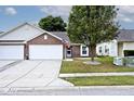 Two-car garage and manicured lawn, curb appeal at 6438 Emerald Springs Dr, Indianapolis, IN 46221