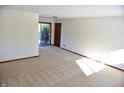 Spacious carpeted basement room with sliding glass door at 6628 E Michigan St, Indianapolis, IN 46219