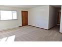 Bright living room with hardwood floors and large window at 6628 E Michigan St, Indianapolis, IN 46219