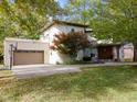 Contemporary home with a two-car garage and basketball hoop at 7812 Preservation Dr, Indianapolis, IN 46278