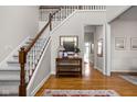 Inviting foyer featuring a staircase, hardwood floors, and a stylish console table with decor at 8552 E 550 S, Zionsville, IN 46077