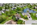 Beautiful aerial view of home with a well maintained yard and a view of the pond at 861 Stardust Ct, Franklin, IN 46131