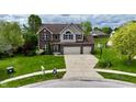 Charming exterior of a two-story home featuring a spacious driveway and well-manicured lawn at 861 Stardust Ct, Franklin, IN 46131