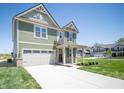 Beautiful two-story home featuring a spacious driveway, lush lawn, and inviting entryway at 8703 Duncan St, Fortville, IN 46040