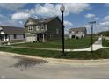 Charming two-story home with manicured lawn on a corner lot at 8703 Duncan St, Fortville, IN 46040