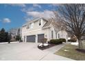 House exterior showcasing a three-car garage and side yard at 11474 Loch Raven Blvd, Fishers, IN 46037