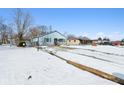 House exterior view with snowy yard and neighboring houses visible at 1650 Stout St, Martinsville, IN 46151