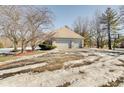 Two-car garage with driveway and basketball hoop in the yard at 179 W Arcadia Way, Mooresville, IN 46158