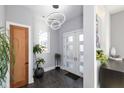 Bright and airy entryway with modern light fixture and double doors at 1948 Central Ave, Indianapolis, IN 46202