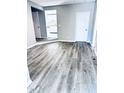 Open living space with gray walls and wood-look vinyl flooring at 2119 Noble St, Anderson, IN 46016