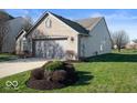 Side view of ranch home showcasing garage and landscaping at 2322 Bainbridge Rd, Greenwood, IN 46143