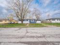 Charming blue one story home featuring freshly landscaped yard, a detached garage, and established trees at 2814 S Randolph St, Indianapolis, IN 46203