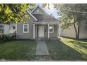 Updated bungalow with a front porch and a sunny front yard at 317 N Belleview Pl, Indianapolis, IN 46222