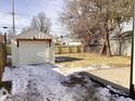 Spacious backyard with detached garage and wooden fence at 3608 N Chester Ave, Indianapolis, IN 46218