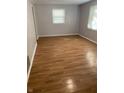 Spacious living room featuring light gray walls and wood-look laminate flooring at 5778 E 30Th St, Indianapolis, IN 46218
