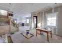 Under construction, large living room with hardwood floors and staircase at 605 Hendricks St, Anderson, IN 46016