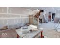 Under construction, large living room with hardwood floors and staircase at 605 Hendricks St, Anderson, IN 46016