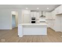 Modern kitchen features white cabinetry, stainless appliances, and spacious layout at 7419 Legends Way, Whitestown, IN 46052