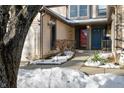 Front entrance with red door and walkway, partially covered in snow at 7952 Sunset Cove Dr, Indianapolis, IN 46236