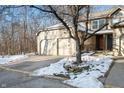 Two-story house with attached two-car garage, snowy landscape at 7952 Sunset Cove Dr, Indianapolis, IN 46236