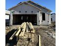 Exterior home construction with lumber in the foreground and visible framing at 1089 Tomahawk Pl, Martinsville, IN 46151