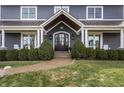 Gray house with a large front door and well-maintained landscaping at 10974 Harbor Bay Dr, Fishers, IN 46040