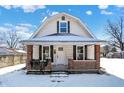 Charming house exterior with brick details and a snow covered yard at 1175 Central Ave, Noblesville, IN 46060