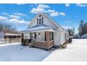 House exterior with brick details and a snow covered yard at 1175 Central Ave, Noblesville, IN 46060