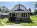 Charming home featuring a welcoming front porch with brick accents and a well-maintained lawn at 1175 Central Ave, Noblesville, IN 46060