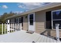 Inviting front porch showcasing a white door and neutral siding at 12160 W Baker Hollow Rd, Columbus, IN 47201