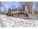 Brick home with a deck, stone retaining wall, and a sunroom at 139 Maplecrest Dr, Carmel, IN 46033