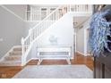 Welcoming foyer showcasing a staircase, hardwood floors, and stylish decor setting an inviting tone at 1535 Cricklewood Way, Zionsville, IN 46077