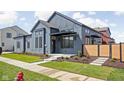 Modern home boasts sleek lines, a covered entryway, fresh landscaping, and a well-maintained lawn at 1674 Solebar Way, Westfield, IN 46074