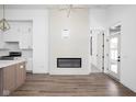 Bright living room with wood floors, modern fireplace, and an open layout connecting to a white kitchen at 1674 Solebar Way, Westfield, IN 46074
