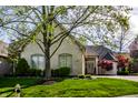 Brick home with lush landscaping and mature trees at 1677 Ashwood Dr, Greenwood, IN 46143