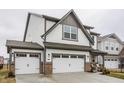 Charming two-story home with white siding, stone accents, and an attached two-car garage at 17227 Barnes St, Westfield, IN 46074